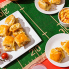 Baked goods on a white plate with a sports-themed tablecloth